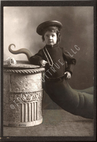 A postcard version of Colin Batty's original cabinet card, "Snake Boy."