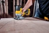 DEWALT DCS335B 20V MAX XR barrel grip jig saw cutting a curved line in wood on a construction jobsite.