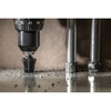 Greenlee GSB09 multi-hole step bit enlarging a hole in sheet metal with a cordless drill for precise conduit and knockout openings.