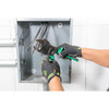 Greenlee 45208G open-jaw ratchet cable cutter cutting soft metal cable in a confined electrical installation area.
