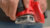 Milwaukee 2524-20 M12 Brushless 2-inch cordless planer in use planing a wood workpiece.