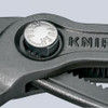 Close-up of the push-button adjustment mechanism on Knipex 8701250 Cobra High-Tech Water Pump Pliers.