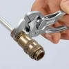 Knipex 8604100SBA 4 Inch Pliers Wrench XS tightening a brass compression fitting on tubing.