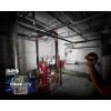 Milwaukee 2107S 325L Focusing Flashlight illuminating a mechanical room during maintenance work.
