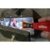 Wiha 25506 12-1000V CAT IV non-contact voltage detector testing for live voltage inside an electrical junction box using the built-in LED work light.