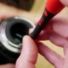 Wiha PicoFinish precision screwdriver being used for camera and electronics repair, providing precise control with an ergonomic rotating cap handle.