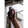 Wiha 53082 SoftFinish XHeavy Duty screwdriver being used to install or adjust hardware, demonstrating the ergonomic grip and heavy-duty striking cap for professional applications.