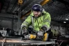 Worker using the DeWalt DCG410WW1 cordless brushless angle grinder for metal grinding and fabrication with an 8Ah XR battery.