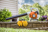STIHL BG 50 handheld gas leaf blower displayed with work gloves and safety glasses for residential lawn and landscape maintenance.