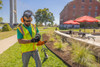 Operator replacing trimmer line on the STIHL FSA 135 R cordless brushcutter during routine maintenance in a commercial landscaping environment.