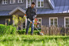 STIHL FSA 50 S cordless trimmer cutting grass around a residential lawn, providing precise and efficient battery-powered trimming.