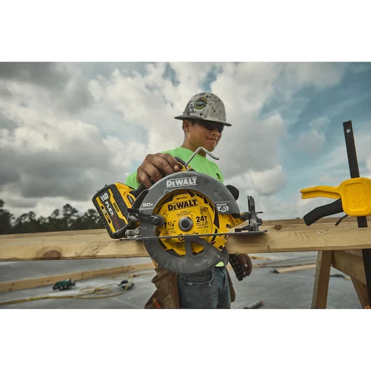 DeWalt DCS578X1 FlexVolt 60V circular saw cutting wood on construction site.