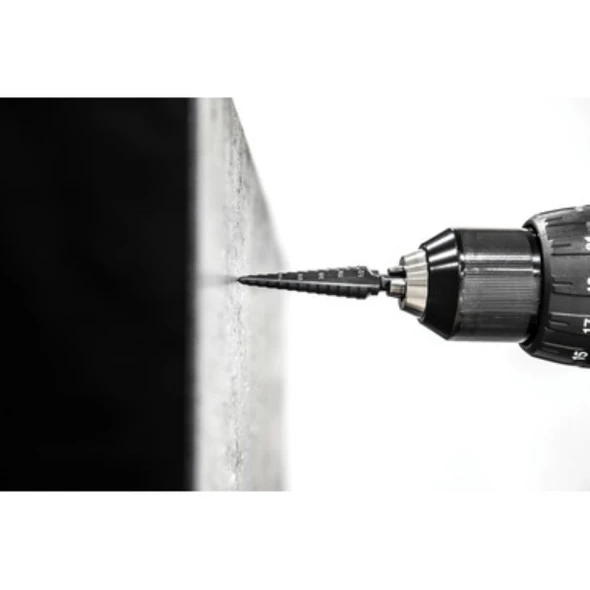 Greenlee GSB01 #1 stepper drill bit drilling through sheet metal with a cordless drill for clean, accurate hole enlargement.