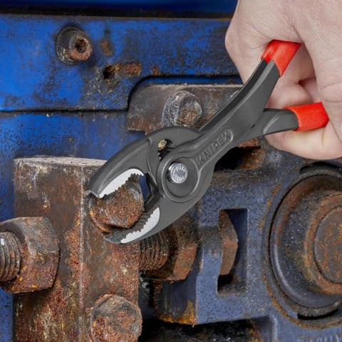 A professional using the Knipex 10-inch Pliers Wrench to securely tighten a chrome fitting without scratching the surface.