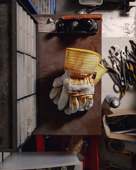 Watson A281BB Econo Grain leather work gloves shown in a workshop environment.