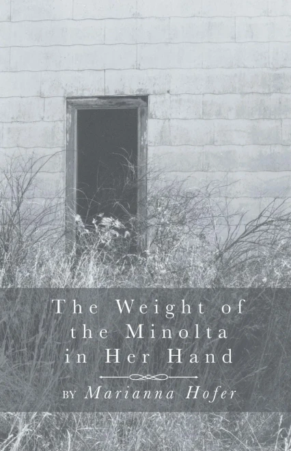 The Weight Of The Minolta In Her Hand