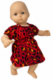 Sidee view Bright red animal print dress for 14–15 inch baby dolls featuring bold black and orange spots, short puff sleeves, gathered neckline, elastic waist, and flared skirt. Shown on a baby doll with blue eyes. Available from Doll Clothes Superstore.