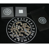 Wooden runes arranged in a circular layout on the black divination tablecloth
