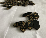 Assorted wooden runes scattered on a light surface showing varied symbols and edges