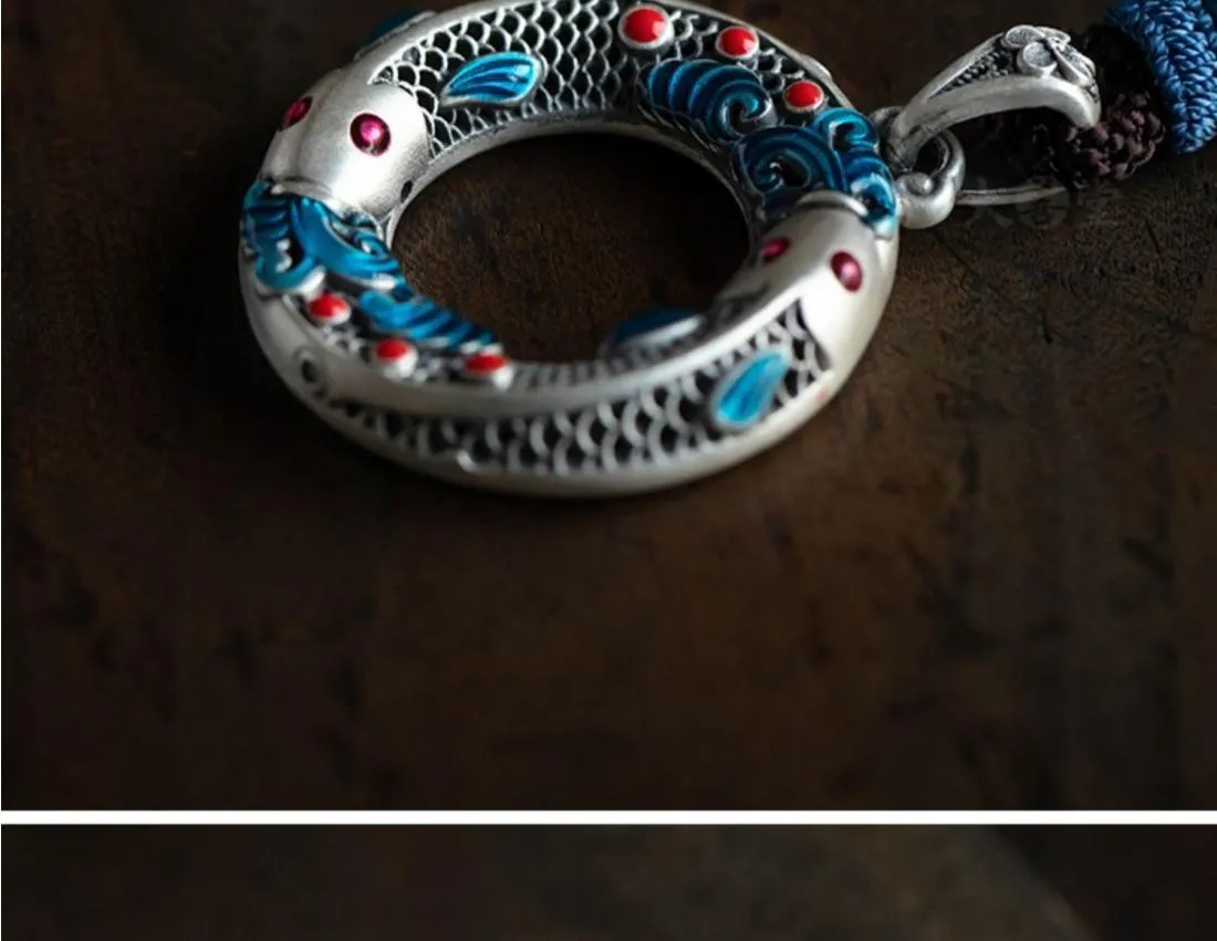 Close-up of hand-painted enamel detail on copper pendant