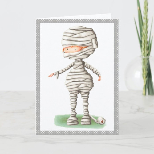 Cute Halloween card with a boy in a mummy costume