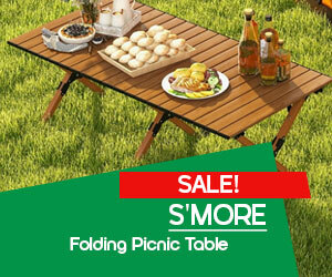 Graphic, wooden folding picnic table with food and drinks on grassy lawn, text, S’more Folding Picnic Table on Sale