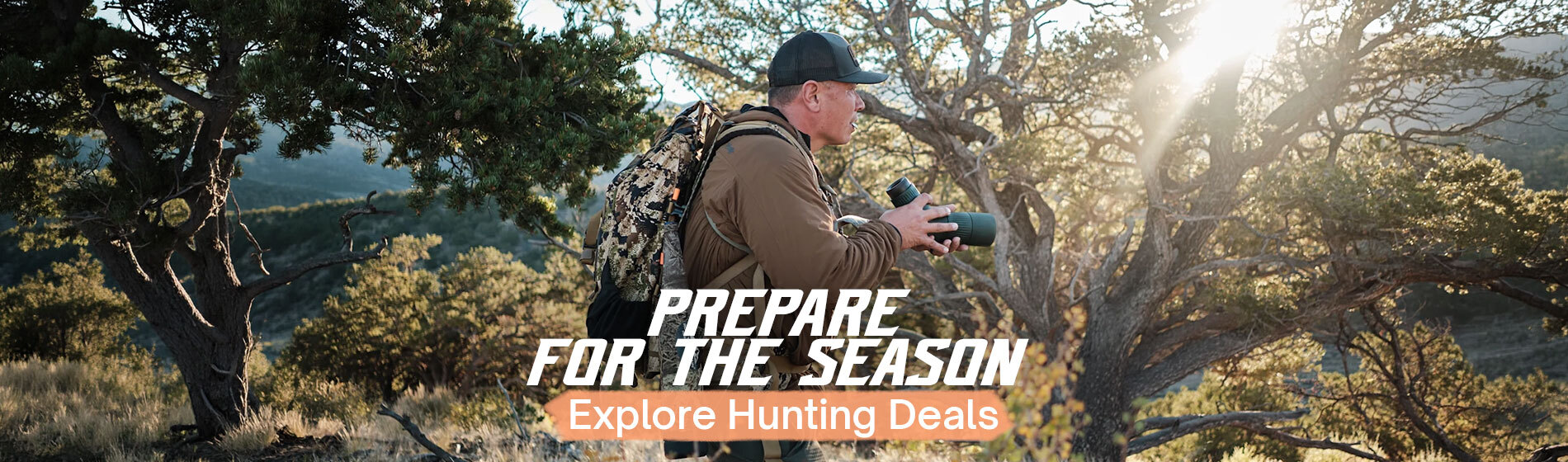 Graphic, a man in a black cap, brown jacket, and camo backpack standing in a rugged, sunlit outdoor landscape holding a spotting scope, text, Gear Up for Hunting Season — Shop Hunting Deals