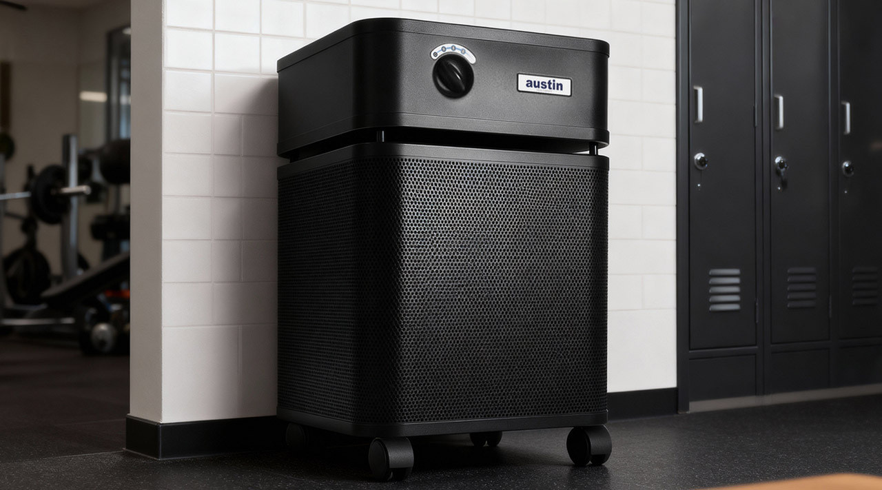 Air purifier for locker room odor control Commercial air purifier positioned for odor control in a gym locker room