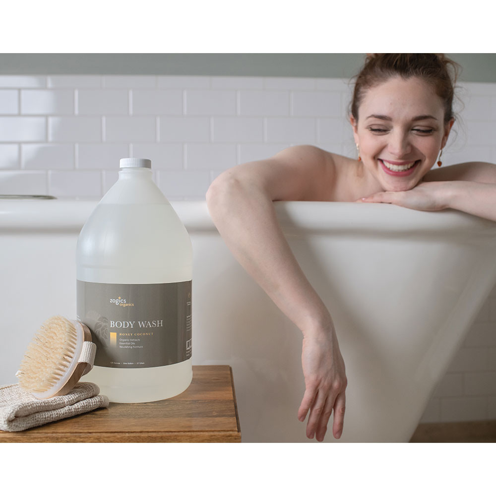 Bulk refill gallons of Zogics Honey Coconut Body Wash shower dispenser
