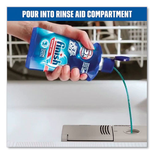 Person placing Finish Jet-Dry rinse aid bottle into dishwasher compartment.