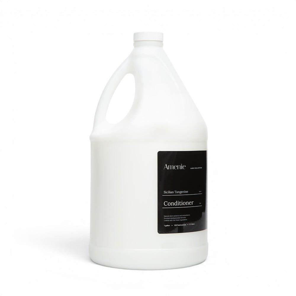 Amenie Sicilian Tangerine Conditioner in a gallon-size bottle with black label on plain white background