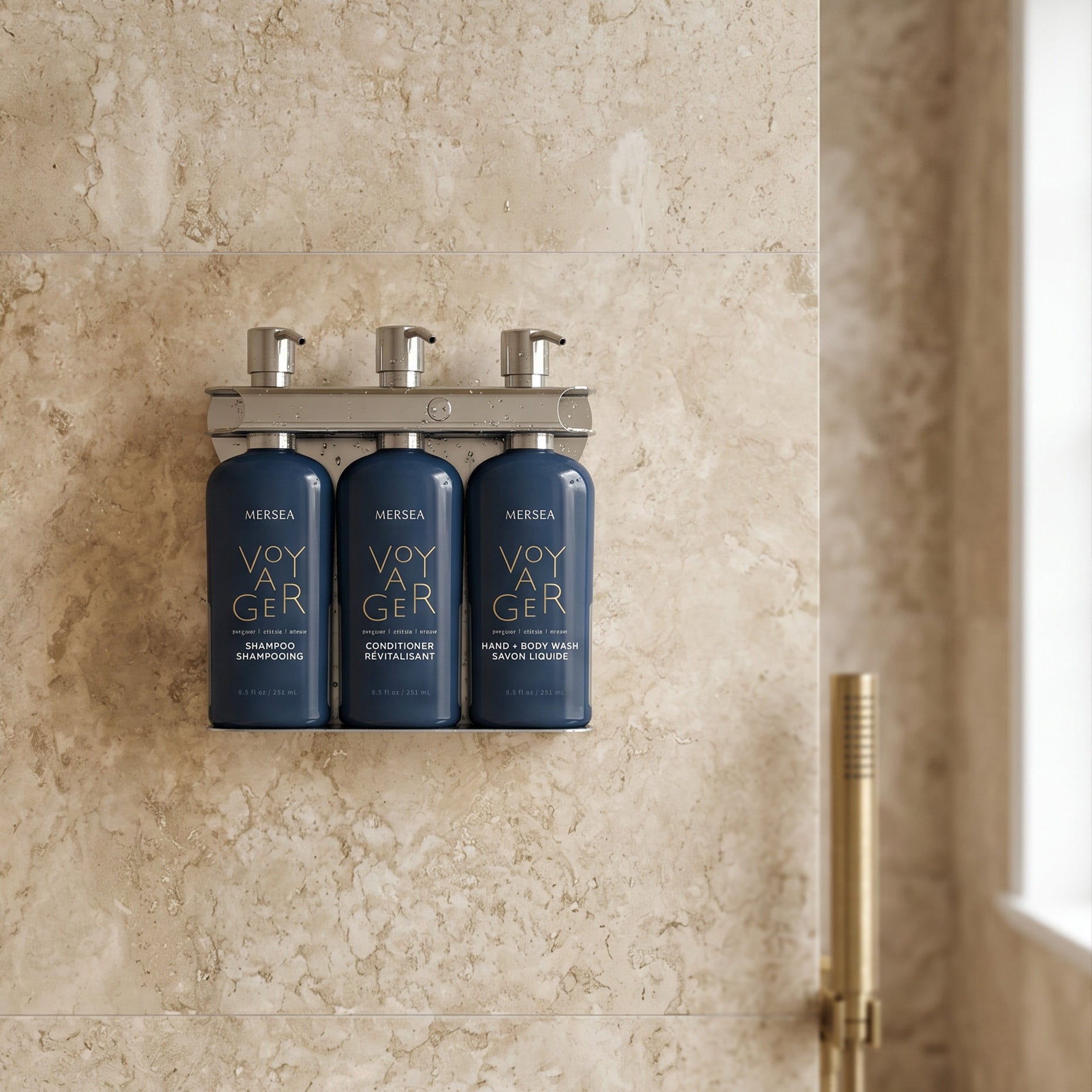 Wall-mounted Mersea Voyager dispenser with shampoo, conditioner, and body wash