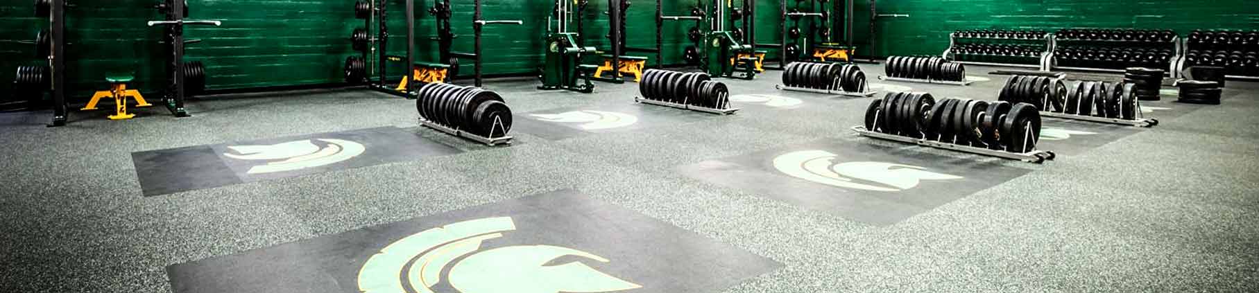 Bench presses on top of rubber flooring tiles for gyms from Zogics.