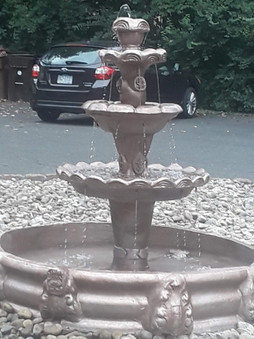 brown hand made stone fountain