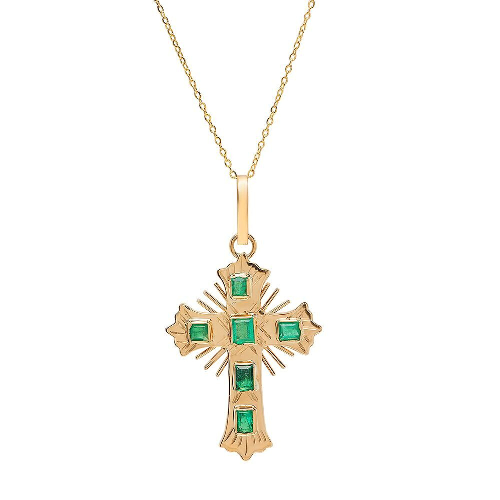 gold cross with emeralds