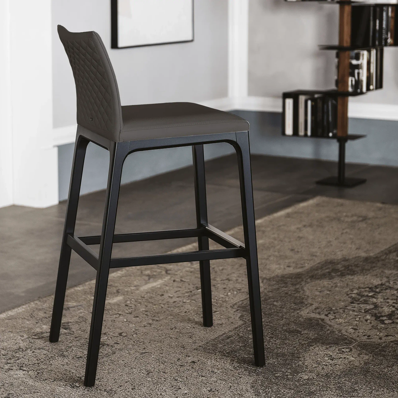 ARDESIA - Cattelan Arcadia Couture Counter Stool in Ardesia Soft Leather and Matt Black Stained Beech, side view in modern room.