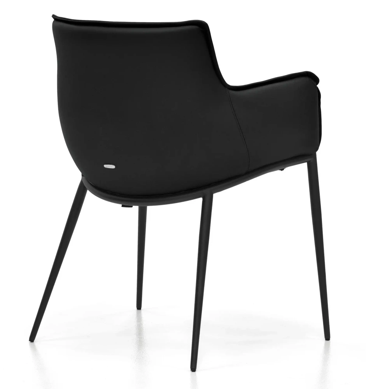 NERO || GRAPHITE EMBOSSED STEEL - Rear view of a modern black leather armchair with slim metal legs and a curved silhouette.