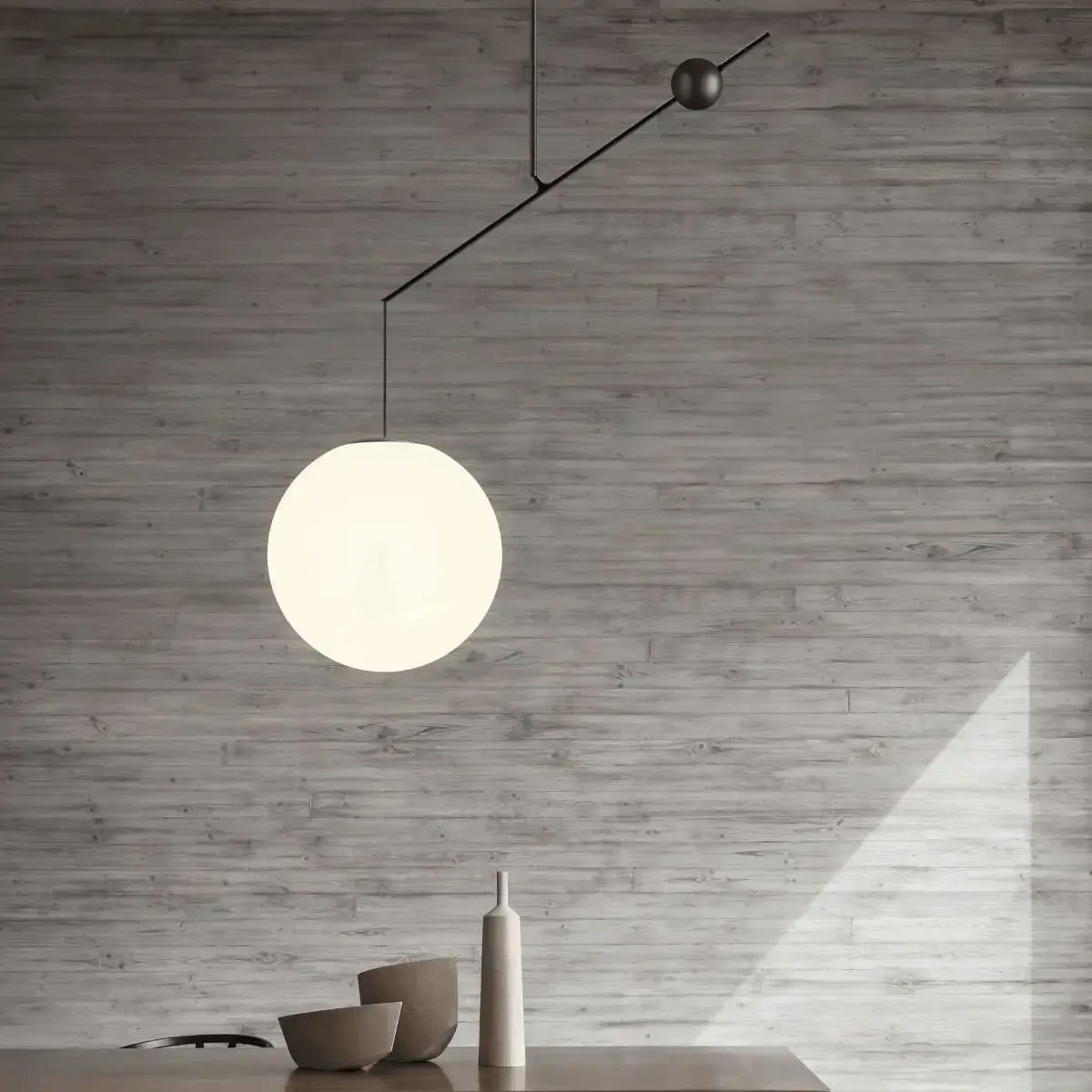 BLACK - Malamata Suspension light, modern matt black steel and opal glass globe, dining room setting, front view.