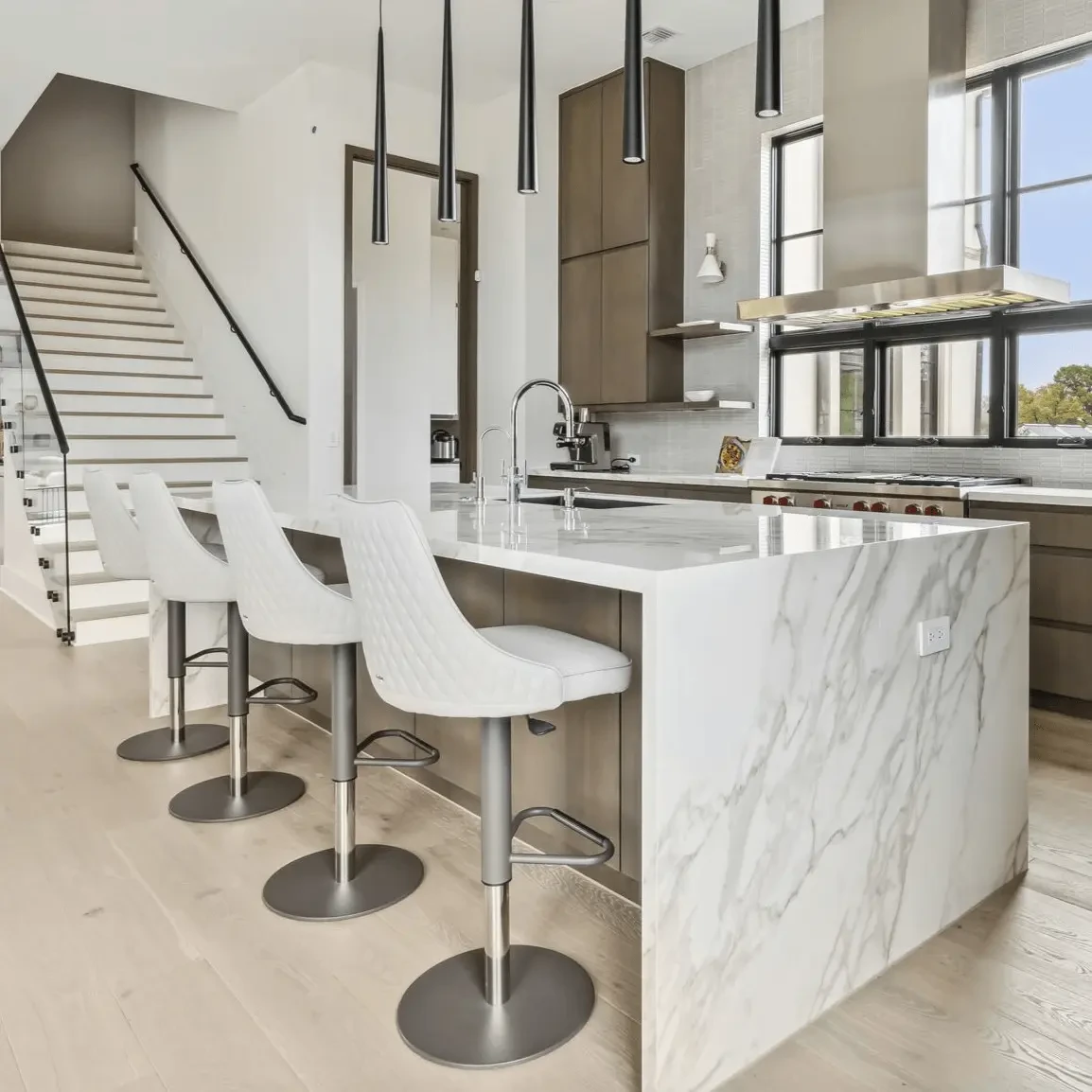 LIGHT GREY ECOPELLE - Four Bontempi Casa Clara Adjustable Bar Stools, Light Grey EcoPelle, Anthracite Frame, in a modern kitchen, side view.