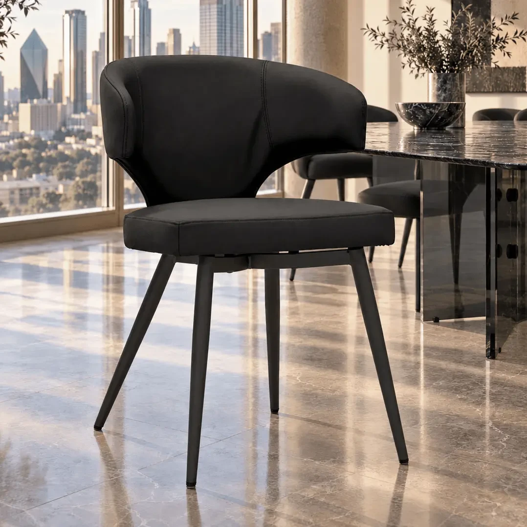 Wing Side Chair in black leather with black powder coat metal legs, modern style, rear view in a dining room setting.