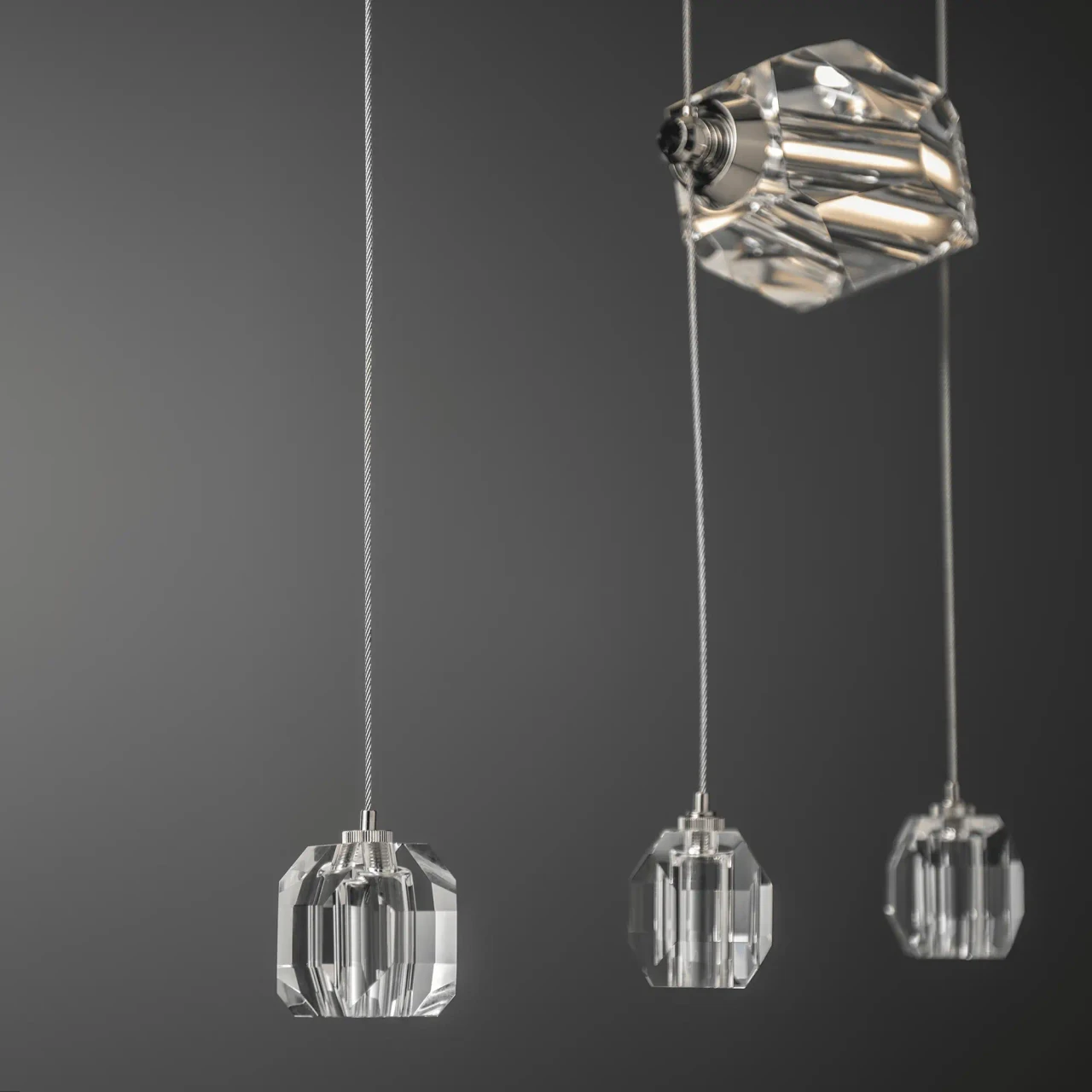 Gatsby 9-light Pendant, modern crystal chandelier with integrated LEDs, close-up angle against a grey background.