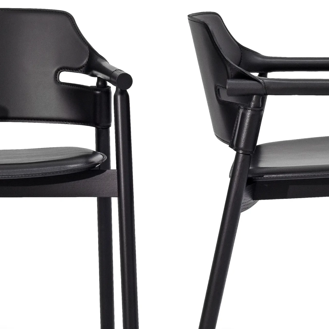 BLACK || Closeup - Suite P Arm Chair, modern style, black hide leather and lacquered ash frame, close-up side view of armrest and legs.