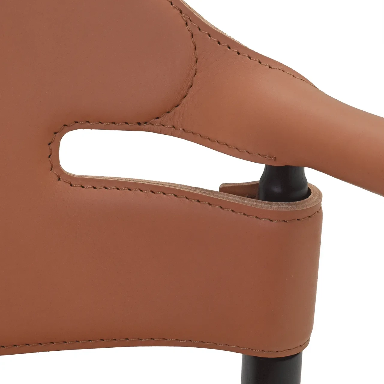 LIGHT COGNAC || Closeup - Close-up of Suite P Arm Chair in Natural Tuscan Hide Leather with Black Lacquered Ash Frame, showing stitched leather detail.