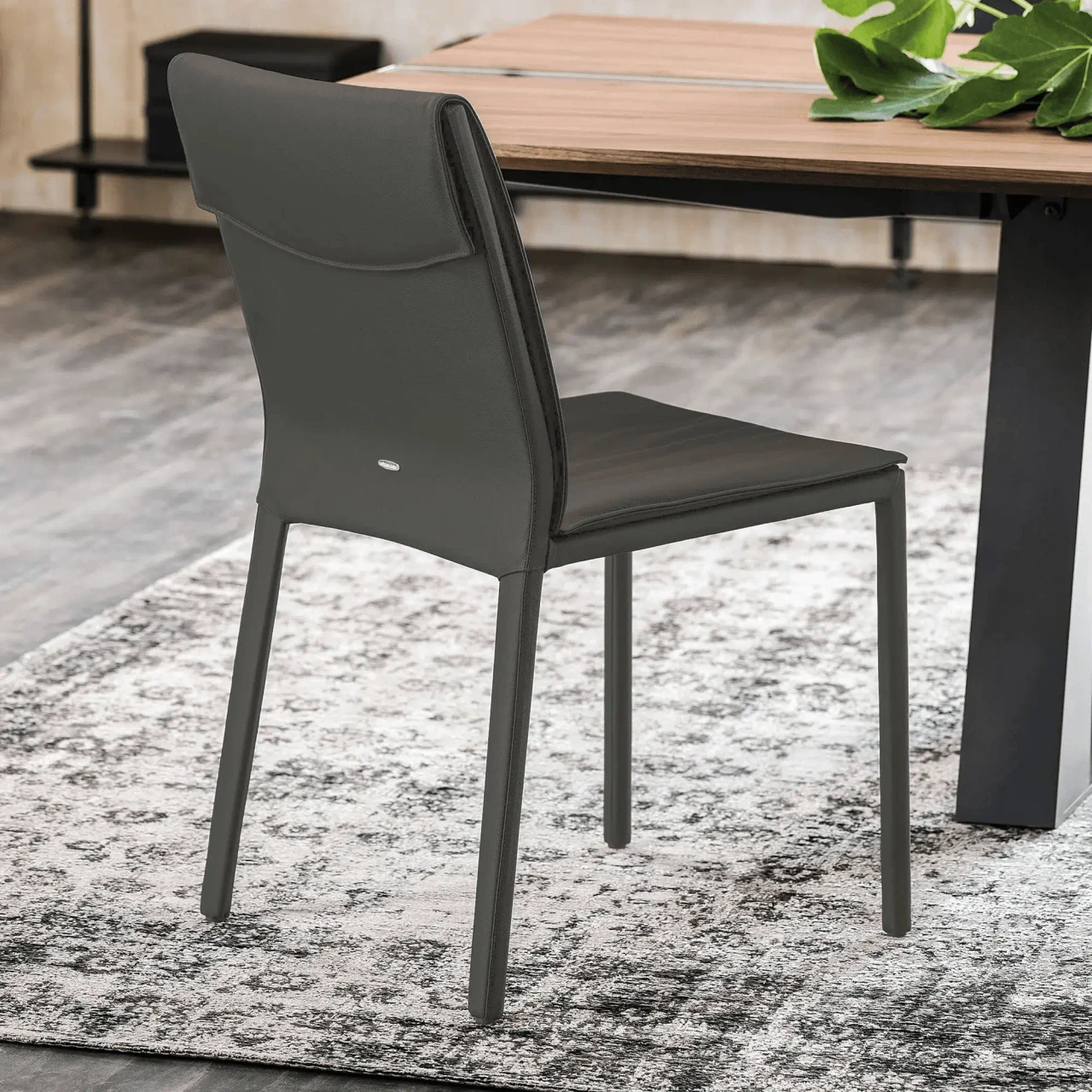 SMOKE - Cattelan Isabel H Side Chair in Smoke Soft Leather, modern style, rear three-quarter view in a dining room setting.