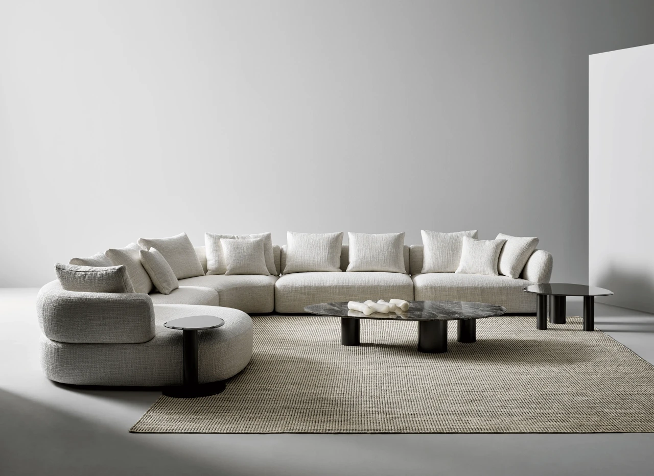 HIGH - Bonaldo Sasso Cocktail Table with glossy grey glass top and lead metal base in a modern living room, front angle view.