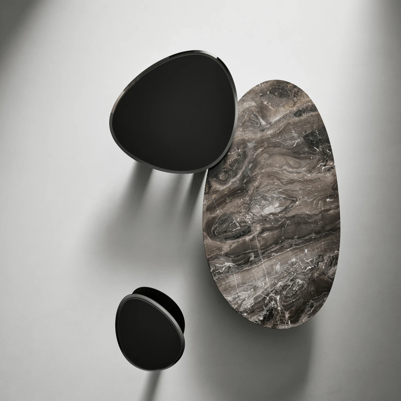 HIGH - Top view of Bonaldo Sasso Cocktail Table with glossy grey glass top and lead metal base in a minimalist living room.