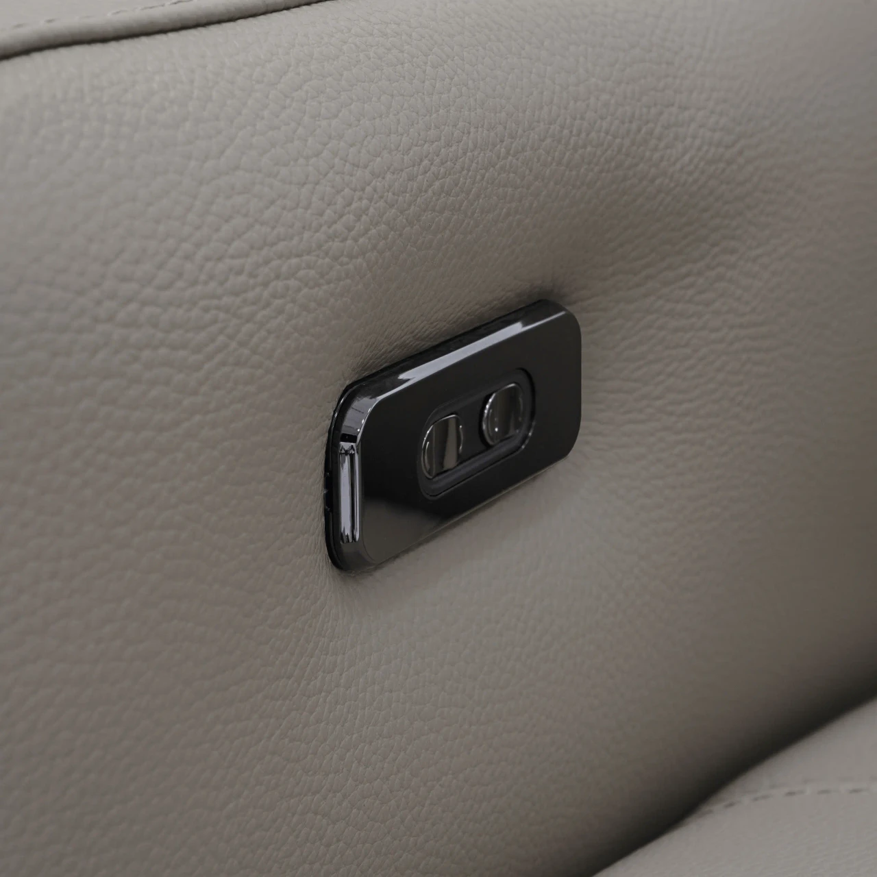 Closeup - Close-up of Valenza Power Sofa in Taupe Leather featuring a black power reclining button.