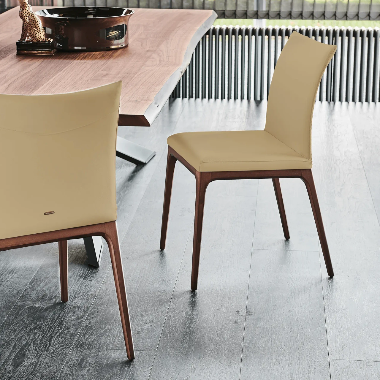SAFARI - Cattelan Arcadia Side Chair in Safari soft leather with walnut stained beech frame, dining room setting, rear angle view.