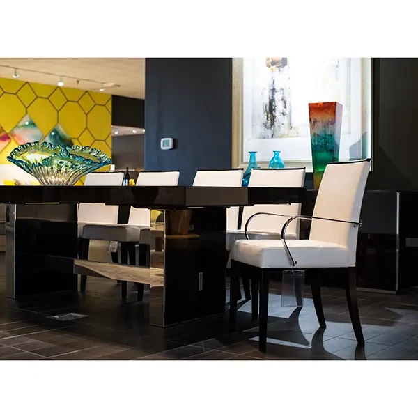 Malerba One And Only Arm Chair in white leather with polished stainless steel arms, modern dining room, side angle view.