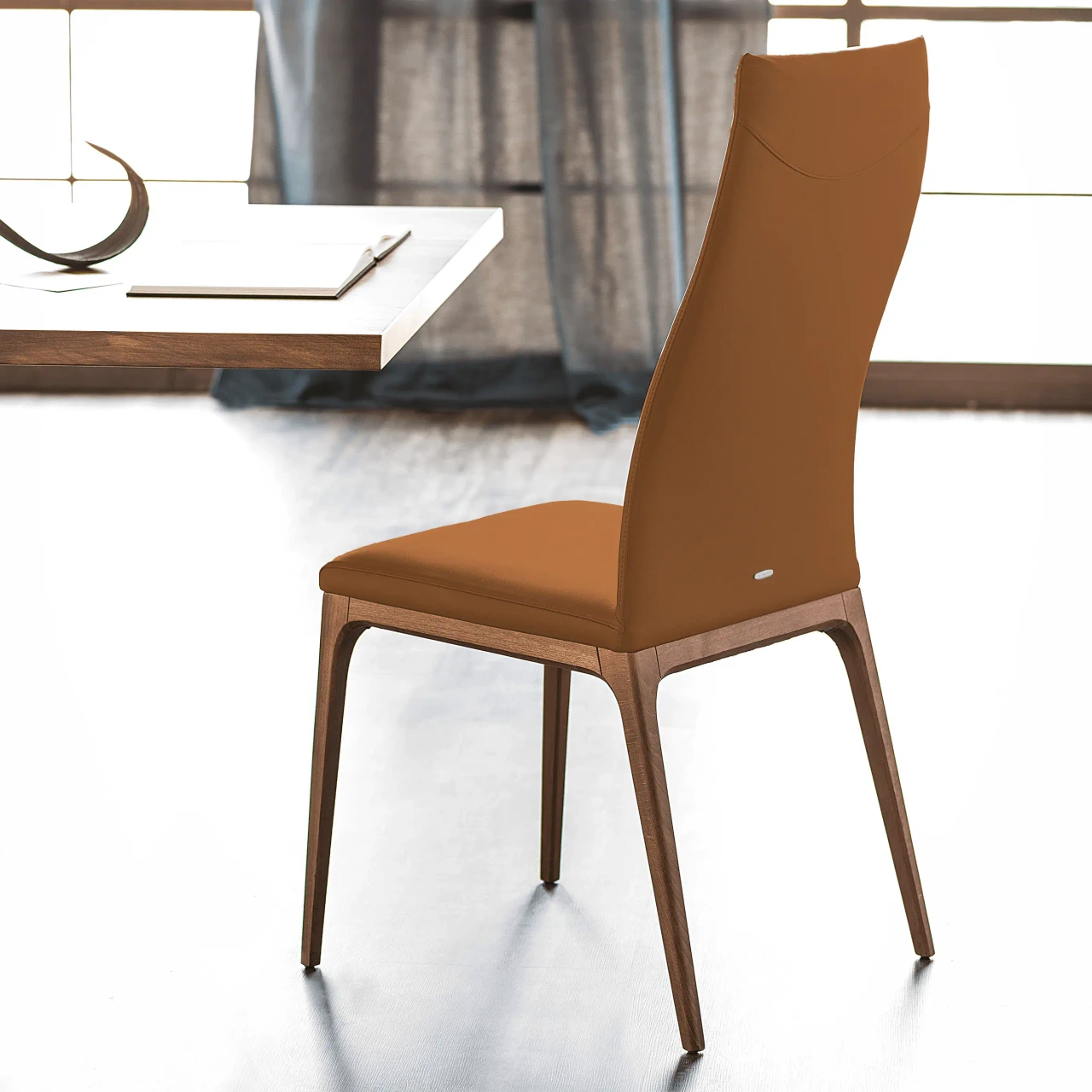 COGNAC || WALNUT - Cattelan Arcadia High Back Side Chair in cognac soft leather with walnut stained beech frame, side view in dining room.